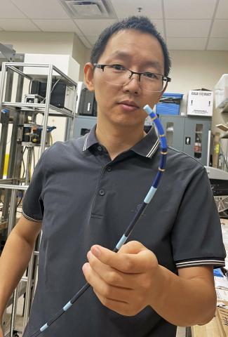 Yue Chen with robotic device Yue Chen with robotic device