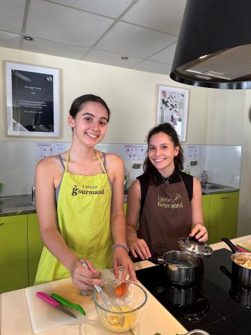 Third-year Biochemistry major Kaya McClincy and third-year Chemical Engineering major Madeline "Maddie" Murdock put the finishing touches on their entrée. Third-year Biochemistry major Kaya McClincy and third-year Chemical Engineering major Madeline "Maddie" Murdock put the finishing touches on their entrée.
