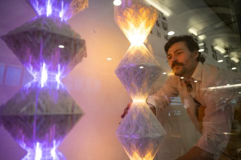 Samuel Thurman installs digitally designed and fabricated lamps in the Atlanta airport. Photo by Rob Felt
